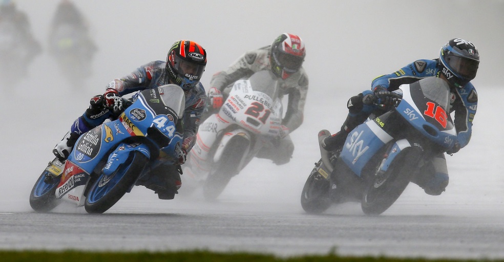 Jorge Navarro riding with other pilots under the rain