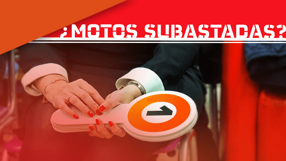 Paleta de subasta con número 1 sujetada por mujer con uñas pintadas